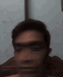 a blurry picture of a man 's face with a white background