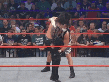 a wrestler wearing a shirt that says tome on it