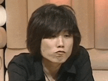 a close up of a woman making a funny face with her mouth open .