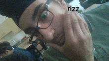 a close up of a person 's face with the word rizz written on it