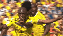 a group of soccer players in yellow jerseys are celebrating a goal on fifa tv