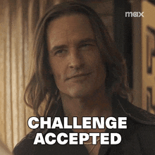 a man with long hair says challenge accepted in black letters