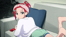 a girl with red hair is laying on a couch