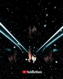 a man and a woman are standing next to each other with the youtube music logo in the background