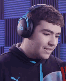 a young man wearing headphones with the letter g on it