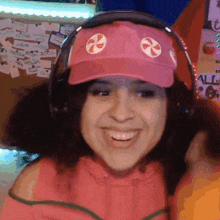 a woman wearing headphones and a pink hat with candy on it