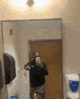 a man is taking a picture of himself in a mirror