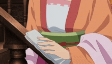 a woman in a kimono holds a piece of paper in her hand