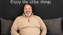 a man sitting on a couch with the words enjoy the little things written above him
