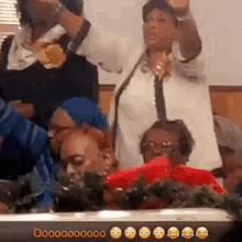 a group of women are standing in a room with their hands in the air