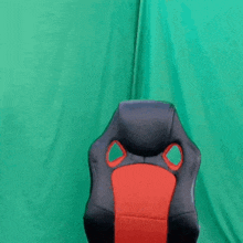 a person is holding a chair with a green background
