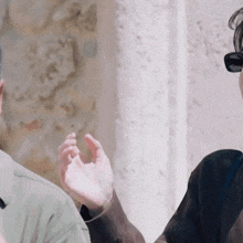 a woman wearing sunglasses is talking to a man