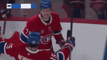 a hockey player with the number 15 on his back is hugging another player