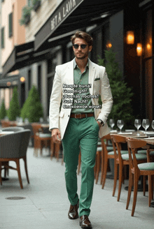 a man in a white jacket and green pants walks down a street