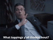 a man in a suit and tie says what toppings y all thinkin bout