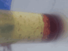 a close up of a yellow and red object on a white background