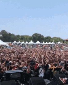 a crowd of people at a concert with a sign that says coca cola on it