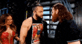 three wrestlers are standing next to each other in a room .