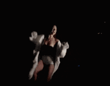 a pixelated image of a woman in a bikini and a white coat