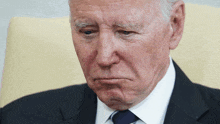 a man in a suit and tie is making a face
