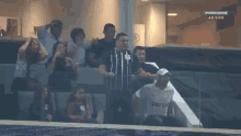 a group of people are watching a soccer game on a premiere channel
