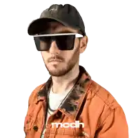 a man wearing sunglasses and a hat with the word mcdh on his jacket