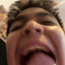 a close up of a man 's face with his tongue out