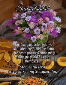 a bouquet of purple flowers sits on a table next to a chris bill book