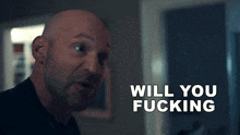 a bald man is smiling with the words will you fucking behind him