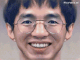 a close up of a man 's face with glasses and a smile .