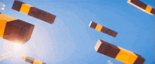 a bunch of blocks are flying in the sky and one of them says ' minecraft '