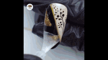 a close up of a person painting a nail with a design on it