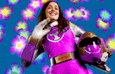 a woman in a pink superhero costume is smiling while holding a helmet