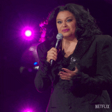 a woman singing into a microphone with the word thank you written below her