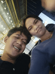 a man and a woman are posing for a picture