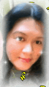 a blurry picture of a woman 's face with a yellow x on it