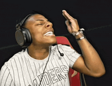 a man wearing headphones and a shirt that says thunders on it