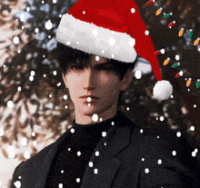 a man wearing a santa hat with snow falling around him