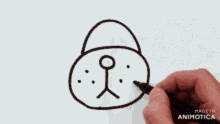 a person is drawing a bear with a black marker and the words made in animatica are visible