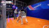 a group of people are playing a game of basketball in front of a wall that says vaunce