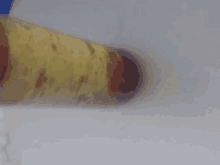 a close up of a yellow object with red spots