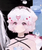 a girl with a crown on her head is standing next to another girl with a crown on her head .