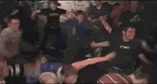 a blurry picture of a crowd of people dancing in a dark room