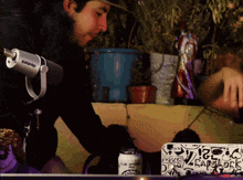 a shure microphone is next to a can of club sprinkler