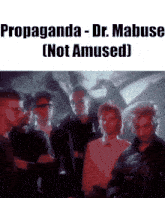 a group of people standing next to each other with propaganda dr. mabus not amused written above them