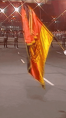 a red and yellow flag with a black stripe that says ' deutsche ' on it