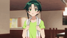 a girl with green hair is wearing a green shirt and a white towel around her neck