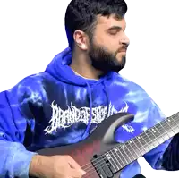 a man wearing a blue tie dye hoodie playing a guitar