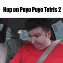 a man in a red shirt is sitting in a car with the words hop on puyo puyo tetris 2 written above him