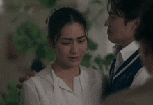 a man and a woman are hugging each other and their eyes are closed